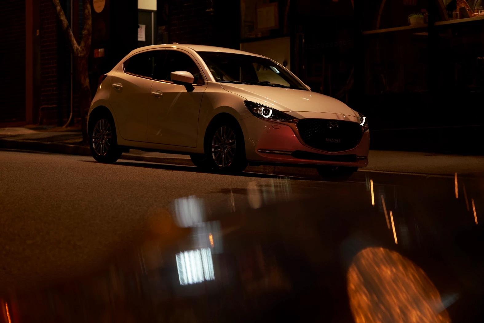 2019 Mazda2 white nighttime front right parked